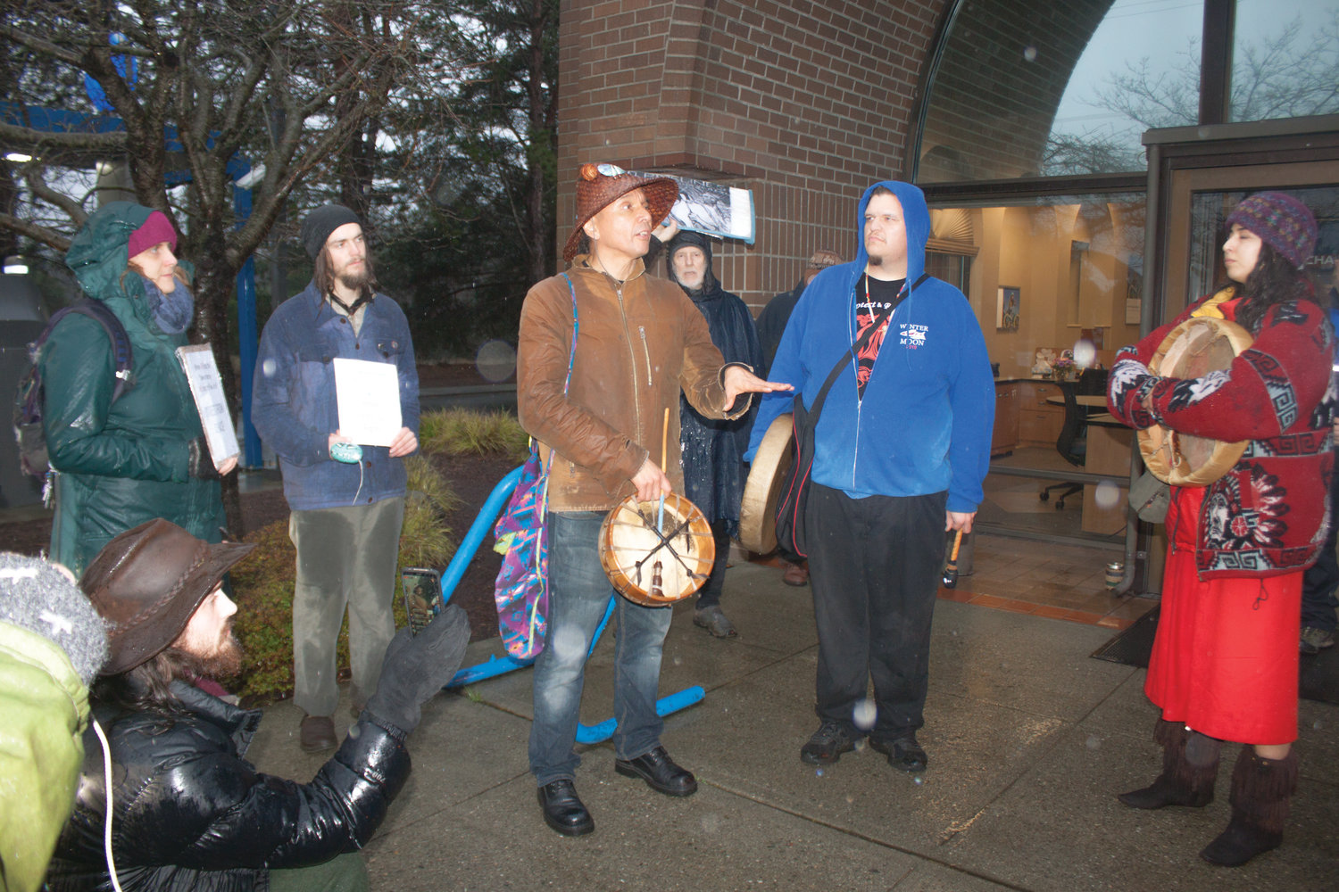 Paul Chiyokten Wagner of the Redmond-based Saanich First Nations and founder of the Protectors of the Salish Sea leads a group of natives and allies in speeches and protest songs outside the Chase Bank branch on Kearney Street Feb. 5.